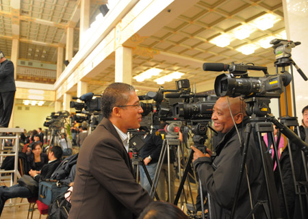 Journalists prepare prior to Chinese Foreign Minister Yang Jiechi&apos;s meeting with the press held by the Second Session of the 11th National People&apos;s Congress (NPC) at the Great Hall of the People in Beijing, capital of China, March 7, 2009. 