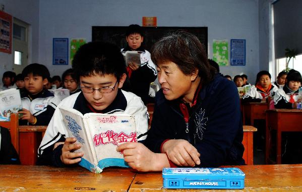 Mother and son share a desk at school