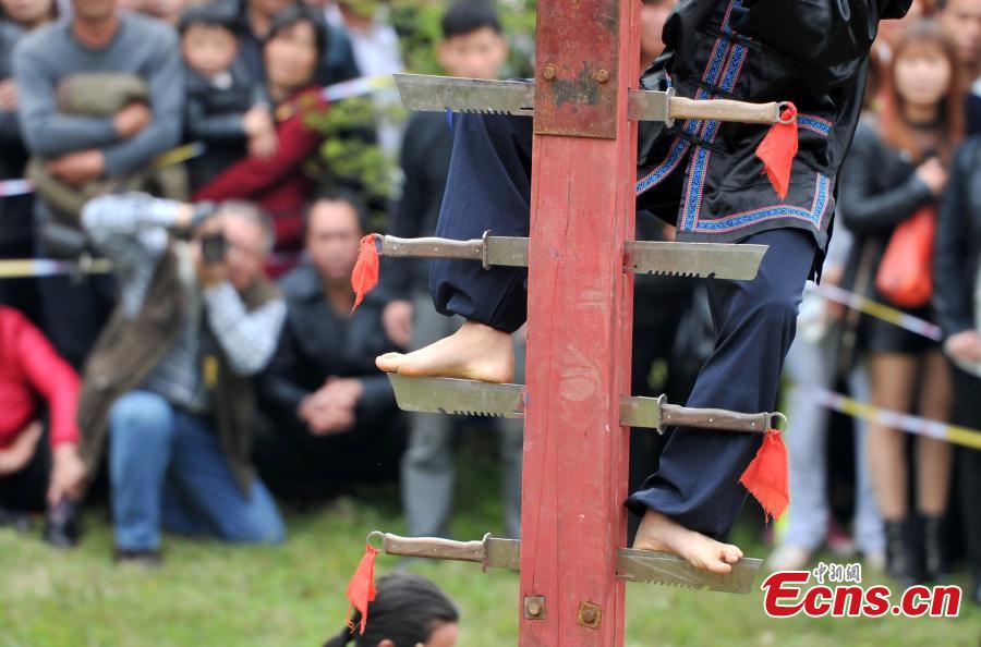 Climbing a ladder of knives to mark Double Third Day festival