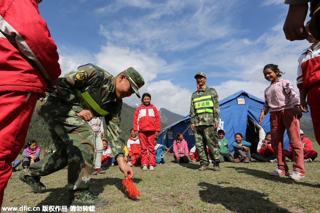 Earthquake relief soldiers have a lighter moment with kids