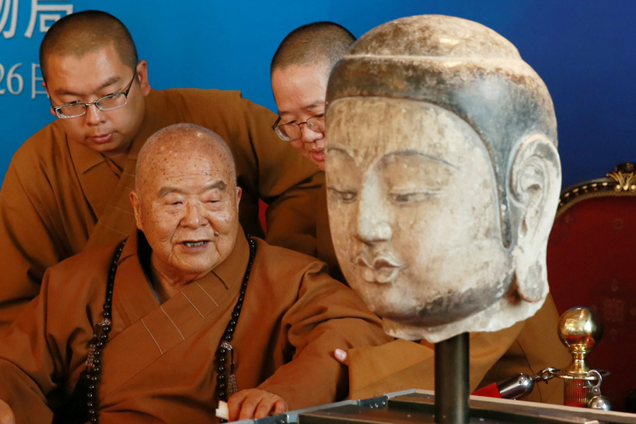 Stolen Buddha head statue returns to Chinese mainland after 20 years