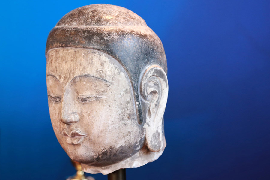 Stolen Buddha head statue returns to Chinese mainland after 20 years