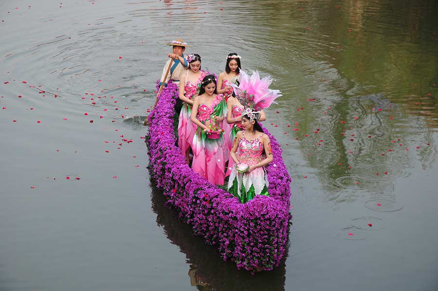 Students in traditional dresses celebrate Women's Day