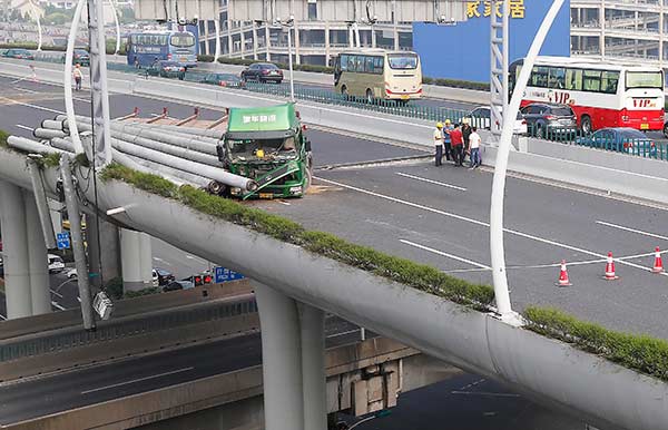 Overloaded truck rolls; highway damaged