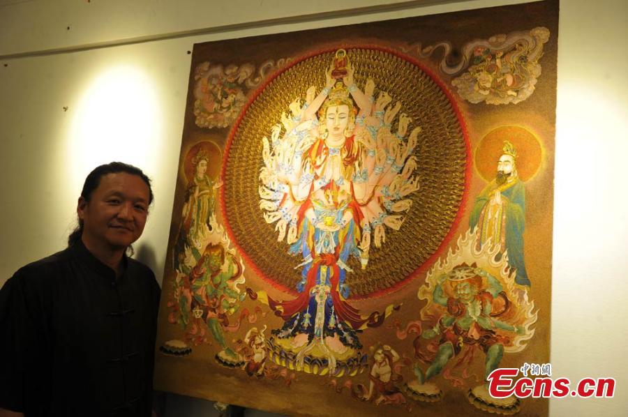 Folk artist uses 4,400 cm of gold wire for enamel art