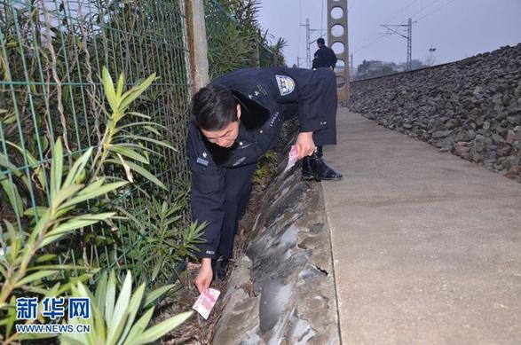 务工者万元现金掉入列车便池散落铁轨 民警冒雨沿路捡回