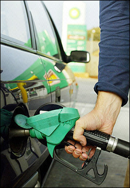 A motorist pumps petrol into a vehicle. World crude oil prices plummeted after a wild ride as investors scrambled to bank profits following news of a weekly surge in US crude oil inventories. [AFP/File]