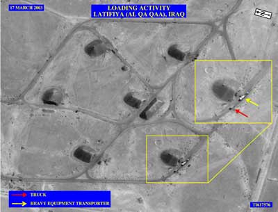 The Pentagon on October 28, 2004 released this aerial photograph, taken two days before the Iraq war, of two trucks at the site where 377 tons of high explosives went missing. The Pentagon said that the photo shows a large tractor-trailer loaded with white containers with a smaller truck parked behind it, but was unable to say that they had anything to do with the disappearance. Picture taken on March 17, 2003. [Reuters]