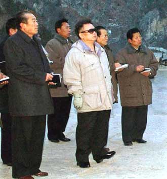 North Korean leader Kim Jong-il (C) inspects power stations under construction in North Korea in this picture released in Tokyo December 15, 2004. North Korea warned Japan on Wednesday that it would treat economic sanctions as a "declaration of war" and threatened to try to exclude Tokyo from six-party talks on Pyongyang's nuclear arms programmes. 