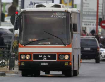 A hijacked bus is seen on a street some 30 kilometres north of Athens December 15, 2004. Greek police forces surrounded the bus after two armed men hijacked it early Wednesday morning with 26 passengers on board on its way from northern Athens suburbs to the Greek capital. [Reuters]