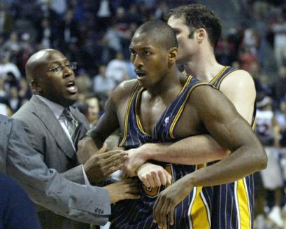 Indiana Pacers' Ron Artest is restrained by Austin Croshere before being escorted off the court following a fight with the Detroit Pistons and fans on Nov. 19 in Auburn Hills, Mich. [AP/file]