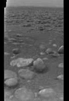 This is one of the first raw, or unprocessed, images from the European Space Agency's Huygens probe as it descended to Saturn's moon Titan January 14, 2005 and released January 14, 2005. [Reuters]