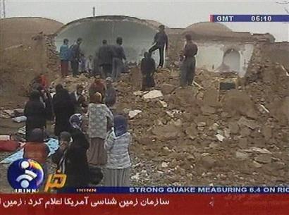 In this image made from Iranian IRINN TV, Tuesday Feb. 22, 2005, showing people searching destroyed buildings in the town of Zarand, Iran, following a powerful earthquake. Several villages have been destroyed in the 6.4 magnitude quake, leaving an unknown number of people dead and injured. [AP]