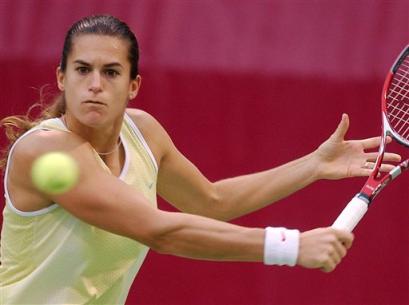 Amelie Mauresmo of France plays a backhand to her opponent Alicia Molik of Australia during the semi final match of the Qatar Open at Khalifa tennis complex in Doha Qatar, Friday Feb. 25, 2005. The match suspended due to the rain. [AP]