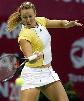 Australian Alicia Molik hits a forehand to French Amelie Mauresmo during their WTA semi-final tennis match in Doha. She produced an awesome display of power to shock top-seeded Mauresmo and set up a dream title clash with Russian Maria Sharapova at the 600,000-dollar WTA Qatar Open. [AFP]