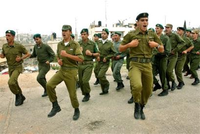 Palestinian police officers march during a training session in the northern West Bank town of Tulkarem Monday March 7, 2005. Despite an attack by Palestinian militants that wounded two Israeli border police in the southern West Bank town of Hebron Monday, both sides said progress has been made on transferring West Bank cities to Palestinian security control, after weeks of deadlock over whether Israel would remove army roadblocks outside the towns as part of such a pullback. [AP]