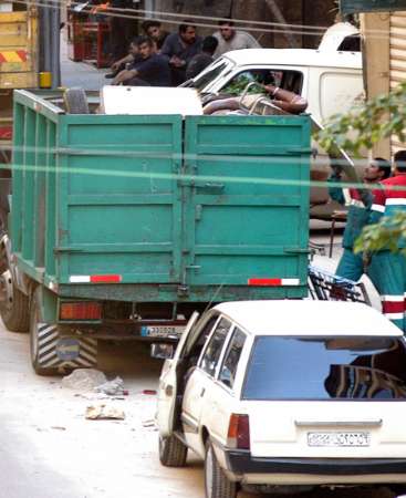 Workers load the furniture of the Syrian intelligence office onto a truck, in Beirut March 15, 2005. Syrian intelligence agents began evacuating their headquarters in Beirut on Tuesday, partially meeting a key U.S. and Lebanese opposition demand for an end to three decades of Syria's tutelage over its neighbor. REUTERS/Stringer 