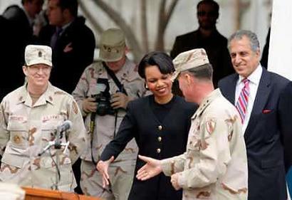 U.S. Secretary of State Condoleezza Rice (C) shakes hands with the U.S. Forces commander in Afghanistan David Barno as U.S. envoy to Afghanistan Zalmay Khalilzad (R) looks on in Kabul March 17 2005. Rice, on her first visit to Kabul, spoke proudly of the progress Afghanistan had made since U.S. forces helped the Afghan opposition oust the Taliban militia in late 2001, after its leaders refused to surrender Osama bin Laden following the September 11 attacks on the United States. [Reuters]
