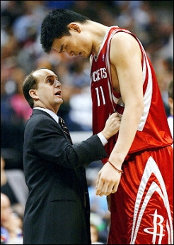 Head coach Jeff Van Gundy of the Houston Rockets talks with Yao Ming during the game against the Dallas Mavericks in Game two of the Western Conference Quarterfinals during the 2005 NBA Playoffs, 25 April 2005 at the American Airlines Center in Dallas, Texas.(AFP
