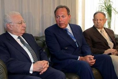 Lebanese President Emile Lahoud (C) sits with head of the press syndicate Mohamed Baalbaki (L) and head of the journalists' syndicate Melhim Karam while paying his respects to slain journalist Samir Qaseer at the press syndicate in Beirut June 2, 2005.