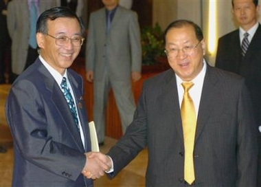 Japan's Finance Minister Sadakazu Tanigaki, left, shakes hands with his Chinese counterpart Jin Renqing in the Chinese port city of Tianjin on Saturday June 25, 2005. Tanigaki is in China to attend a meeting of Asian and European financial leaders that begins on Sunday. (AP