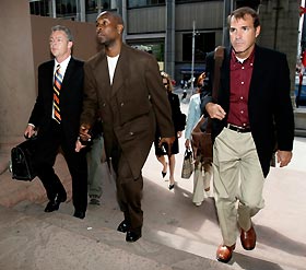 Boston Celtics NBA player Gary Payton (C) arrives with his family lawyer Craig Gilbert (R) for a court appearance to face assault charges in Toronto July 6, 2005.