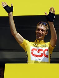 CSC team rider Jens Voigt of Germany waves on the podium before the start of the 192km (119 miles) 10th stage of the 92nd Tour de France cycling race between Grenoble and Courchevel, July 12, 2005.