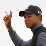 Tiger Woods of the U.S. acknowledges the crowd after scoring a birdie during the first day's play of the British Open in St. Andrews July 14, 2005. The 134th British Open finishes July 17.