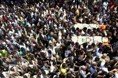 Palestinians attend the funeral procession of two slain Islamic Jihad and Al Aqsa brigades militants Ibrahim Abahrah and Warrad Abahrah, who were killed during a gunfight with Israeli soldiers, in the village of Yamoun near the West Bank town of Jenin, Tuesday, July 19, 2005. 