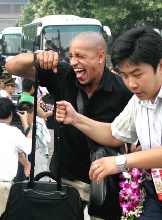 Brazil's soccer player Roberto Carlos (L) of Real Madrid arrives at a welcome ceremony at Xianghe town in Hebei Province, eastern Beijing July 20, 2005. Real Madrid starts a four-day tour to China on Wednesday and will face Beijing Guoan in a friendly match at Beijing Workers' Stadium on Saturday. 