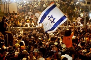 Supporters of the Jewish settler movement gather as they are prevented from leaving the area near the village of Kfar Maimon, in southern Israel near the Gaza Strip, Wednesday, July 20, 2005. Israeli police and army encircled an encampment of Gaza pullout opponents preventing them from marching to the nearby Gaza Strip. (AP