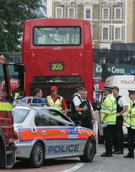 Police surround a bus near Kings Cross, London,Tuesday Aug. 2, 2005. The bus caused a security incident after smoke was spotted coming from it, but was later given the all clear by police and the bomb squad. (AP 