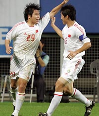 China's forward Li Jinyu (L) celebrates with team mate Ji Mingyi after scoring against Japan in the first half of their East Asian Football Championship match in Taejon, South Korea August 3, 2005. China tie 2-2 with Japan in the match. [Reuters] 