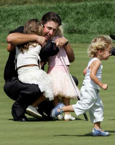 Phil Mickelson of the U.S. greets his children on the 18th green after winning the 2005 PGA Championship at Baltusrol Golf Club in Springfield, New Jersey, August 15, 2005. 