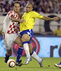 Ronaldo (R) of Brazil and Josip Simunic of Croatia chase the ball during their friendly match in the Adriatic port city of Split August 17, 2005. 