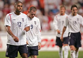 England's Glen Johnson (L), Wayne Rooney (2nd L), David Beckham (2nd R) and Owen Hargreaves (R) leave the pitch following the international friendly soccer match against Denmark at the Parken Stadium in Copenhagen, Denmark, August 17, 2005. Denmark won 4-1. 