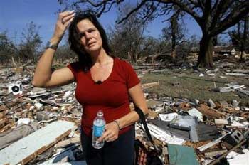 'Oh my poor dog,' bemoans P.J. Ralph Tuesday, Aug. 30, 2005 in Biloxi, Miss., as she surveys damage to what remains of the Quietwater Beach Apartments complex. Authorities believe at least 30 people lost their lives in the complex when Hurricane Katrina made landfall Monday. Ralph, who had only been a resident for nine months, said she lost more than just her dog, 'I lost my friends, my possessions, everything.' [AP]