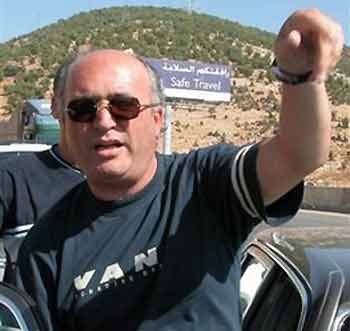 Former Lebanese legislator Nasser Qandil gestures while stepping into his car after he talked to the media at the Masnaa border crossing, on the outskirts of the Bekaa Valley, east of Beirut, Lebanon, Tuesday, Aug. 30, 2005.