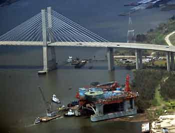 An oil rig that had collided with a bridge sits along the shore after being towed off in Mobile, Alabama after Hurricane Katrina struck August 31, 2005.