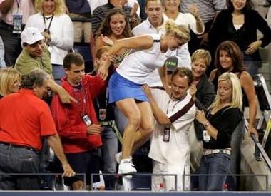 Kim Clijsters of Belgium climbs into the crowd to greet her family following her win over Mary Pierce of France in the final of the U.S. Open tennis tournament in Flushing Meadows, New York, September 10, 2005. 