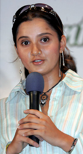 Indian tennis player Sania Mirza watches Indian schoolgirls as she attends a school reception in the eastern India city of Kolkata, previously known as Calcutta September 19, 2005. Mirza will receive extra security after an Islamic group opposed to her on-court dress threatened to stop her from playing in next week's WTA event, police said on Friday. [Reuters]