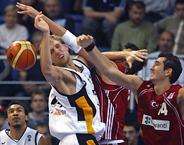 Germany's Dirk Nowitzki (3rd R), who also plays for the NBA's Dallas Mavericks, fights for the ball with Turkey's Kaya Peker (2nd R) and Mehmet Okur (R), from the NBA's Utah Jazz, as Demond Greene (C) watches during their European basketball championship match in Vrsac, September 20, 2005.