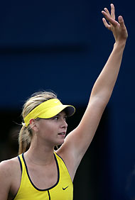 Maria Sharapova of Russia waves to spectators as she celebrates her win over Israel's Shahar Peer during their women's singles match at the China Open tennis tournament in Beijing September 22, 2005. Sharapova beat Peer 6-0 5-7 6-2. 