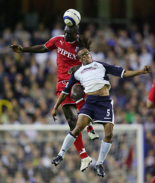 Tottenham Hotspurs' Edgar Davids (R) challenges Fulham's Papa Bouba Diop during their English Premier League soccer match at White Hart Lane in London, England September 26, 2005.