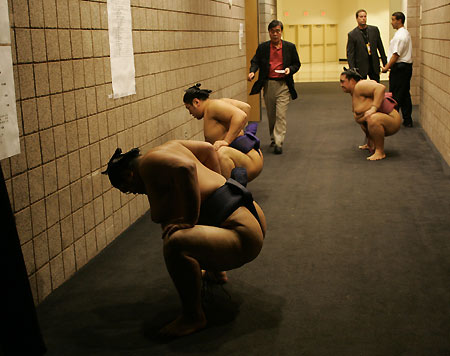 Sumo Wrestlers stretch in a hallway before the start of the second day of the Grand Sumo Las Vegas tournament at the Mandalay Bay Events Center in Las Vegas, Nevada October 8, 2005. The tournament continues through October 9. [Reuters]
