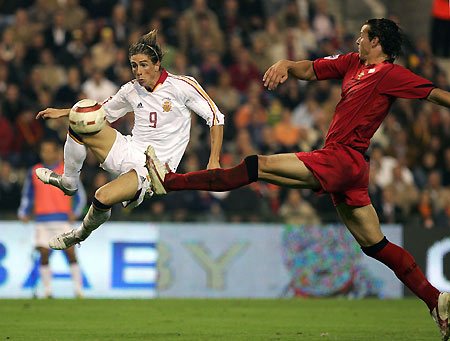 Spain's Fernando Jose Torres scores a goal in front of Belgium's Daniel Van Buyten (R) during their 2006 World Cup European zone Group Seven qualifying match at the King Baudouin stadium in Brussels October 8, 2005. [Reuters]