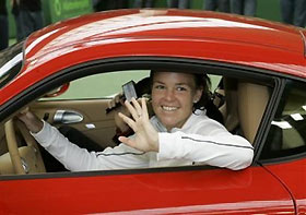 Lindsay Davenport from the USA waves after taking a seat in a Porsche Cayman S sportscar she was awarded after her victory against Amelie Mauresmo of France in the final of the Porsche Tennis Grand Prix in Filderstadt near Stuttgart, southwestern Germany, Sunday, Oct. 9, 2005.