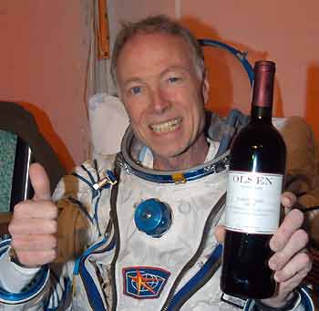 U.S. space tourist Gregory Olsen gives a thumbs up while holding a bottle of wine inside a medical tent after landing near the town of Arkalyk in northern Kazakhstan October 11, 2005. A Soyuz space capsule touched down safely in Kazakhstan on Tuesday, bringing a Russian-U.S. crew back to earth from the International Space Station.