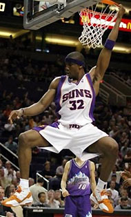 Phoenix Suns forward Amare Stoudemire hangs from the rim after a slam dunk against Utah, in Phoenix, in this March 12, 2004 photo.