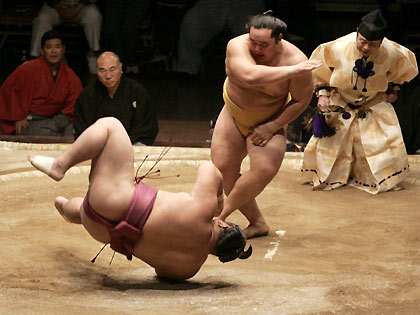 Mongolian sumo wrestler Asashoryu (R) throws down Chiyotaikai (L) of Japan to win the grand championship during the third day of the Grand Sumo Championship Las Vegas tournament at the Mandalay Bay Events Center in Las Vegas, Nevada, October 9, 2005. Asashoryu won the third day final and went on to defeat Chiyotaikai and Tochiazuma to clinch the grand championship.